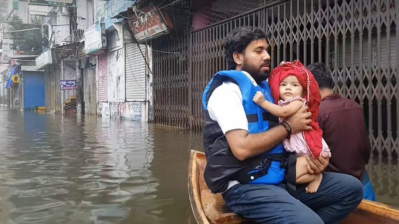 সম্প্রতি ফেনীতে বন্যাকবলিত একটি ভবনের সিঁড়ি থেকে শিশুটিকে উদ্ধার করে মায়ের কাছে পৌঁছে দেন স্বেচ্ছাসেবীরা